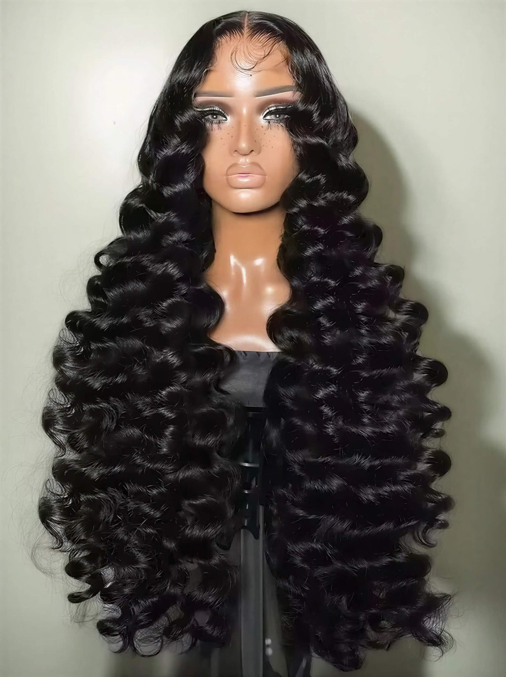 300 density loose wave HD lace wig displayed on a mannequin with long, shiny black curls cascading down.